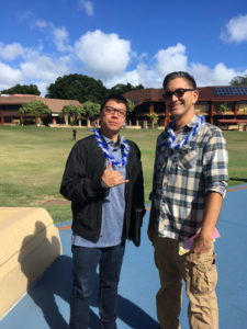Alfie Gonzales and Sheldon Tawata pose in front of KCC's Great Lawn.