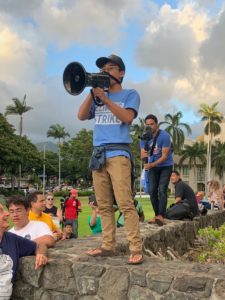 With megaphone in hand, Dyson Chee leads a climate strike.